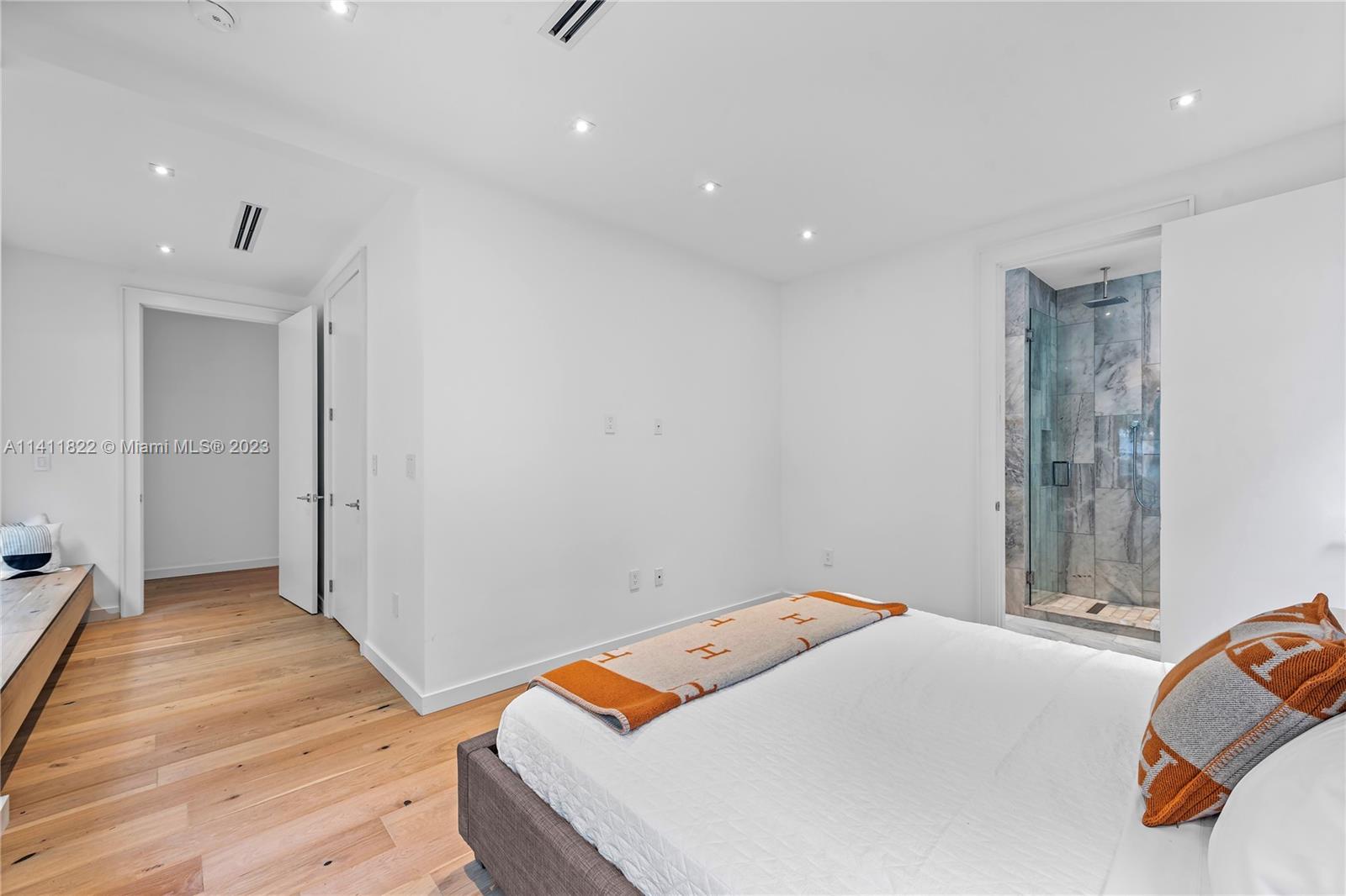 5956 Pine Tree Drive Miami Beach, FL 33140 - Photo 24 of 55 a bedroom with a bed and a couch