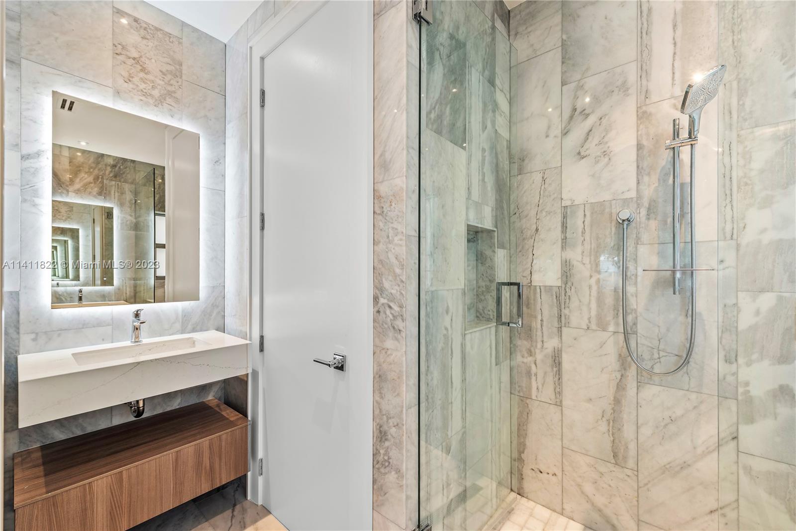 5956 Pine Tree Drive Miami Beach, FL 33140 - Photo 26 of 55 a bathroom with a shower and a sink