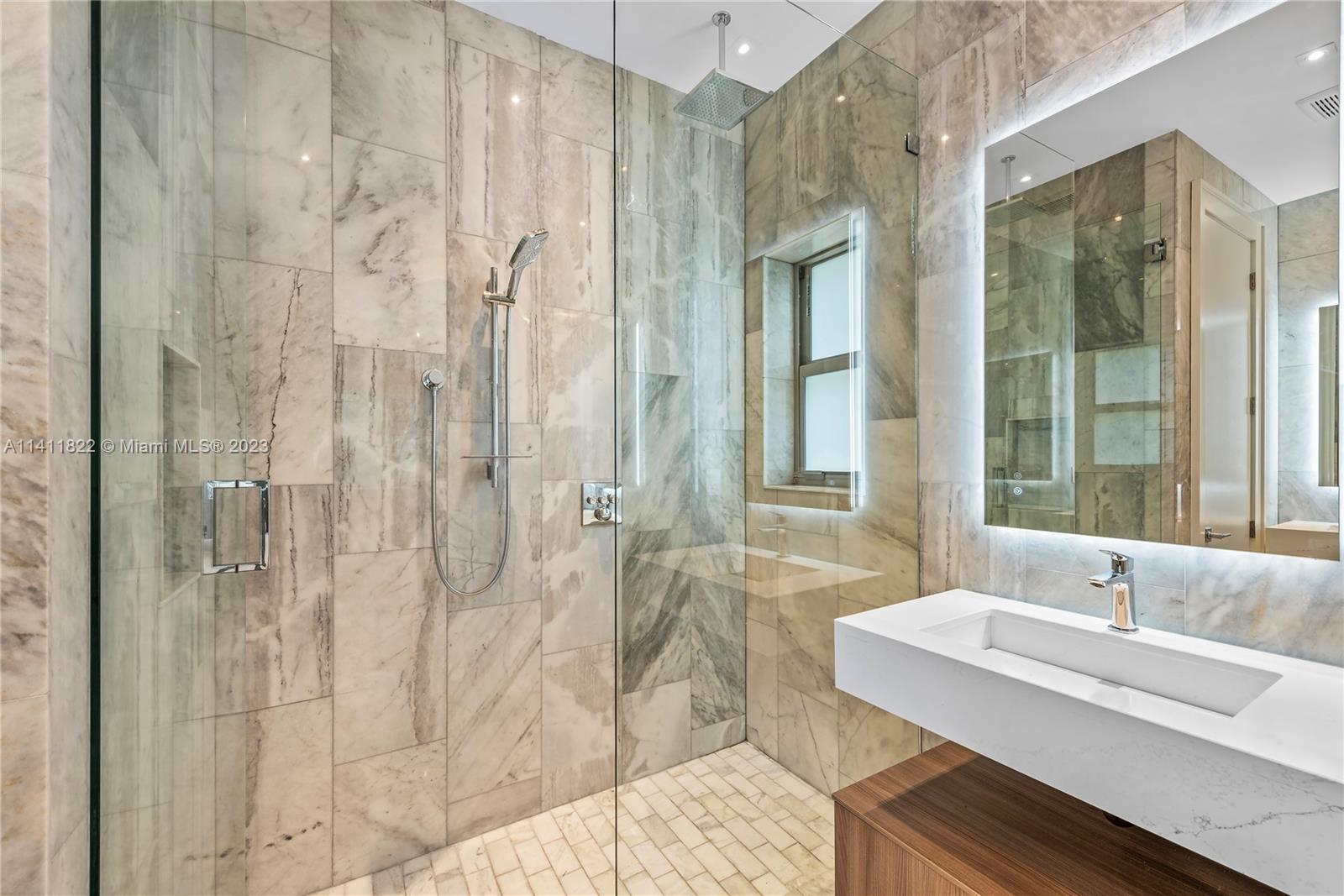 5956 Pine Tree Drive Miami Beach, FL 33140 - Photo 27 of 55 a bathroom with a granite countertop sink a toilet and shower