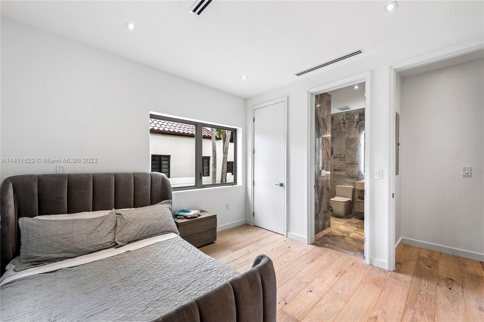 5956 Pine Tree Drive Miami Beach, FL 33140 - Photo 29 of 55 a bedroom with a bed and wooden floor