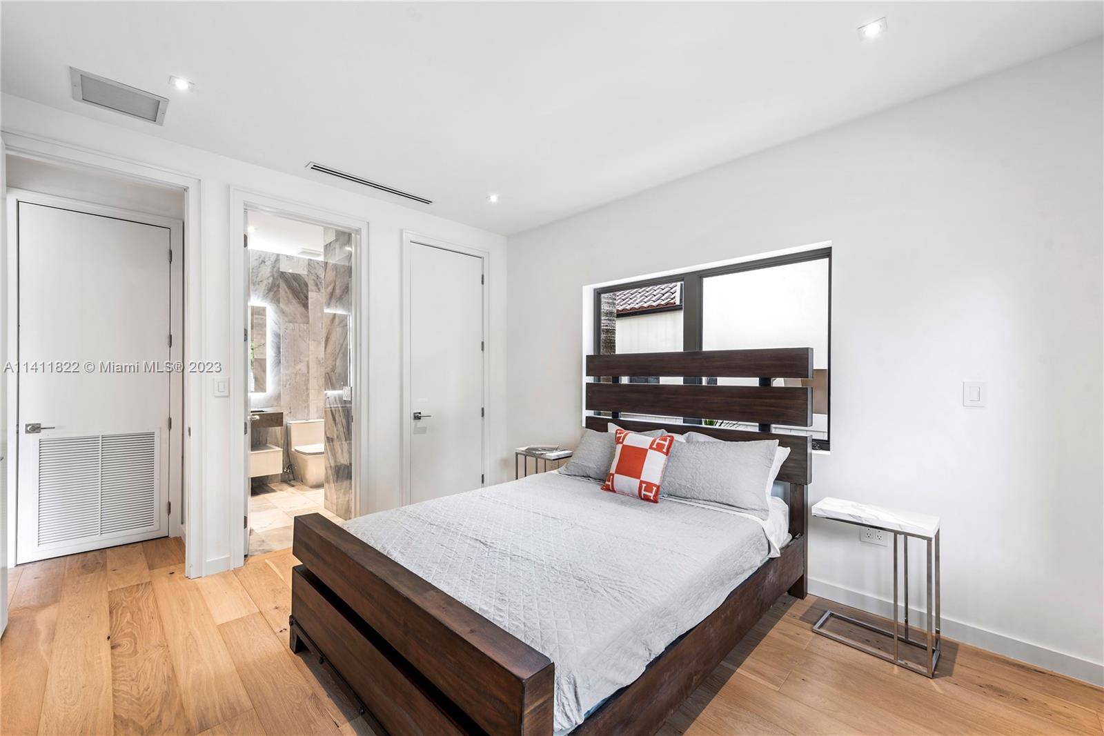 5956 Pine Tree Drive Miami Beach, FL 33140 - Photo 32 of 55 a bedroom with a bed and a window