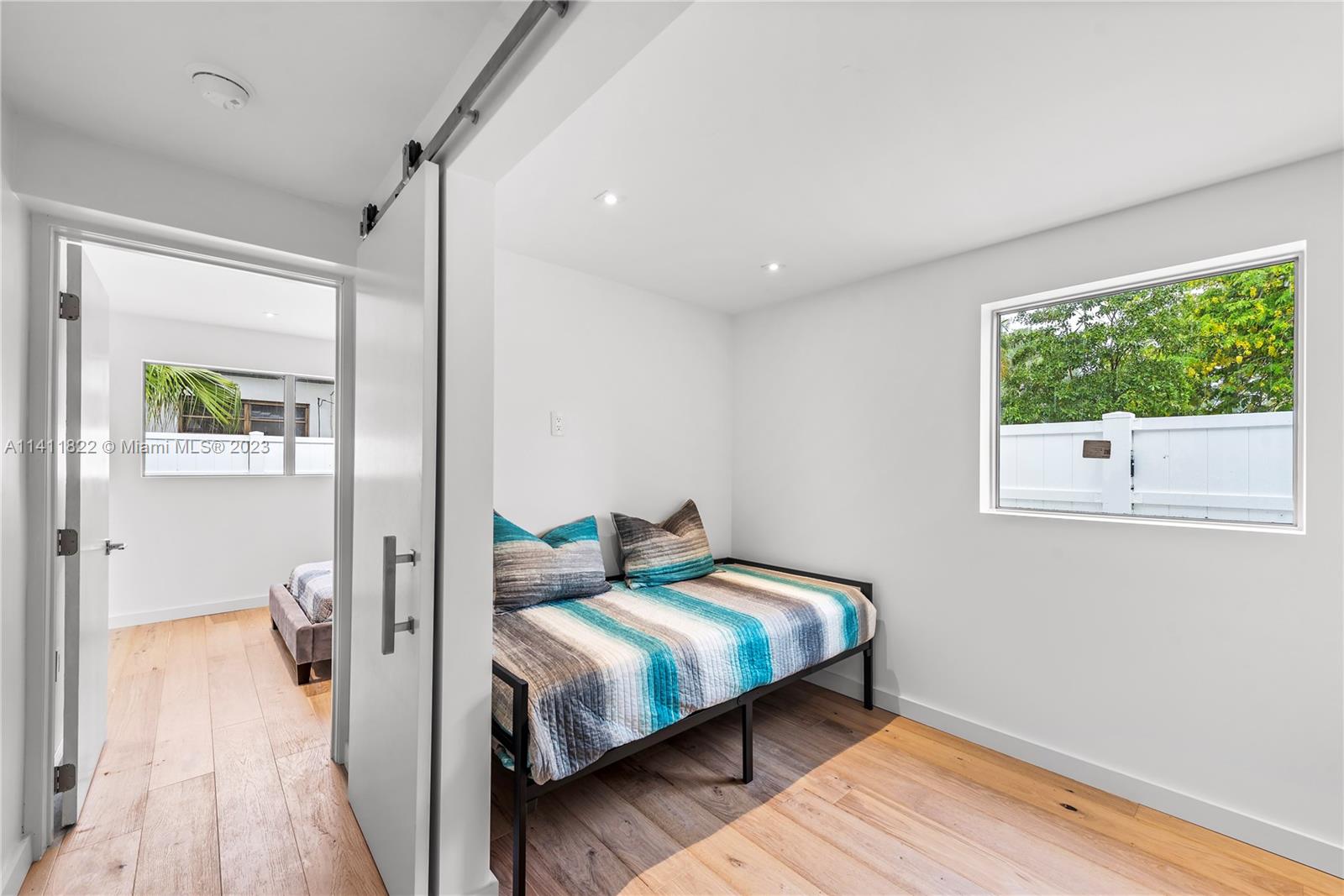 5956 Pine Tree Drive Miami Beach, FL 33140 - Photo 38 of 55 a bedroom with a bed and wooden floor