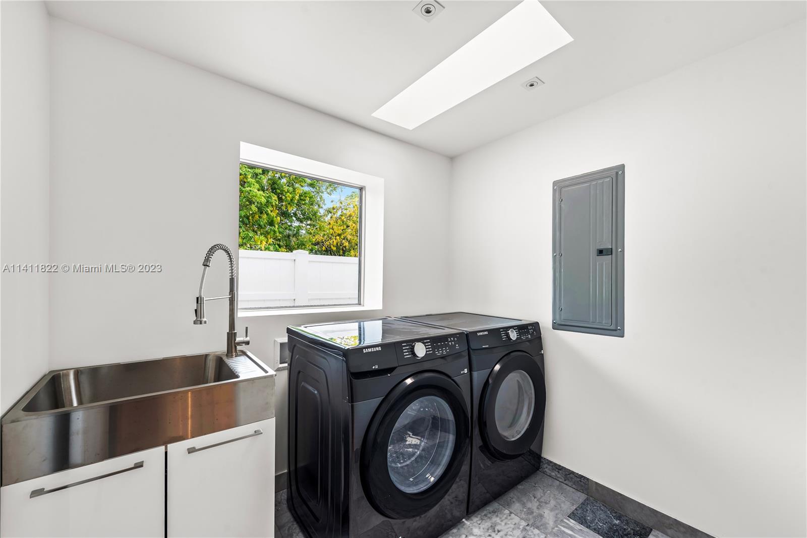 5956 Pine Tree Drive Miami Beach, FL 33140 - Photo 39 of 55 a utility room with dryer and washer