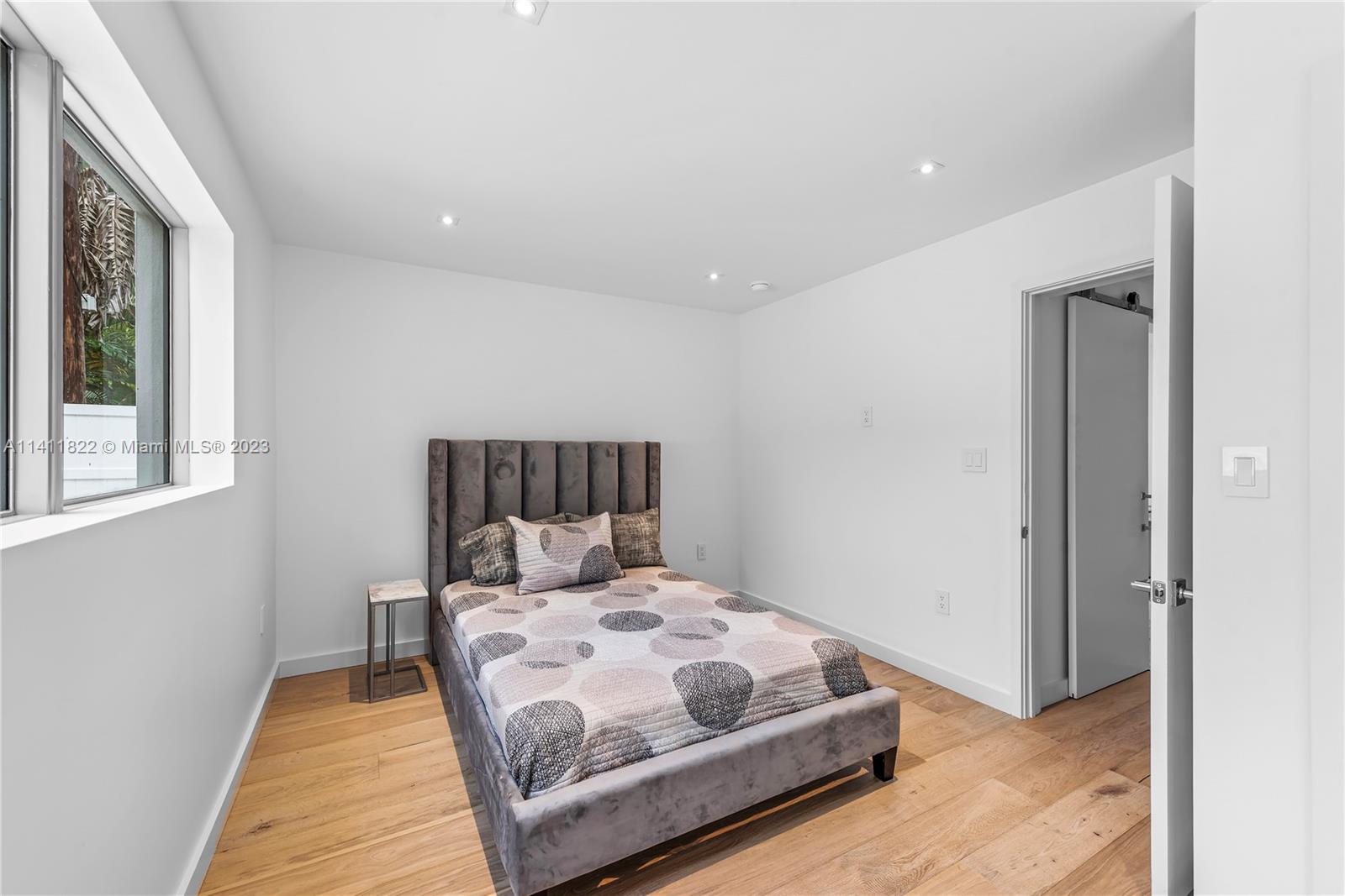 5956 Pine Tree Drive Miami Beach, FL 33140 - Photo 40 of 55 a bedroom with a bed and window