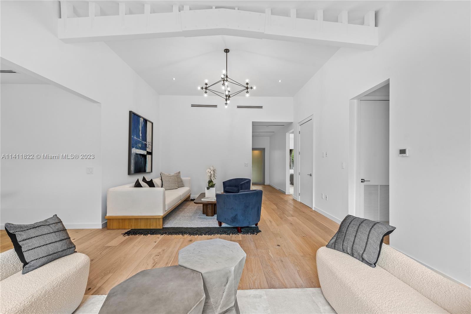5956 Pine Tree Drive Miami Beach, FL 33140 - Photo 4 of 55 a living room with furniture and a chandelier