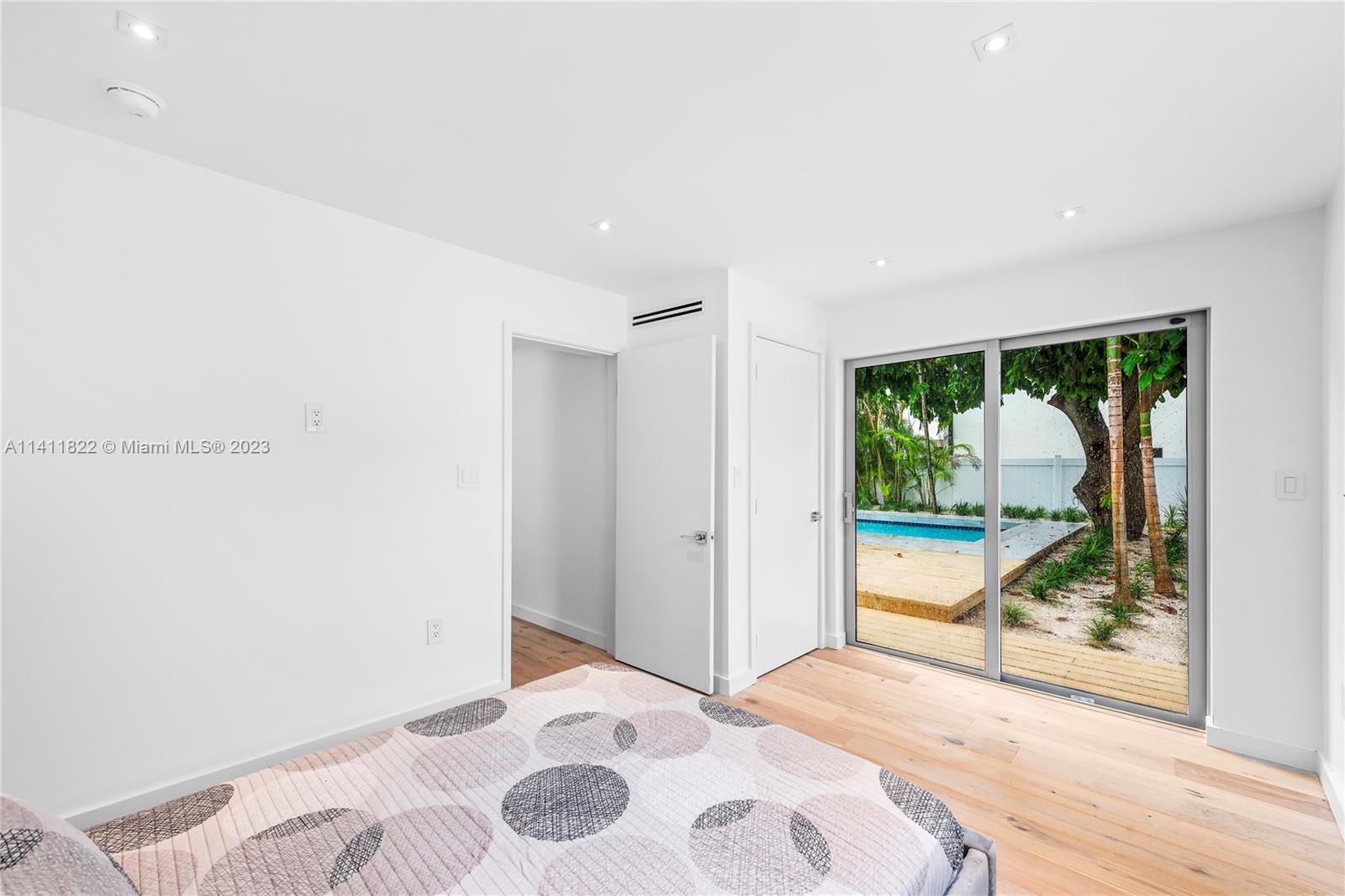 5956 Pine Tree Drive Miami Beach, FL 33140 - Photo 41 of 55 a bedroom with a bed and a large window