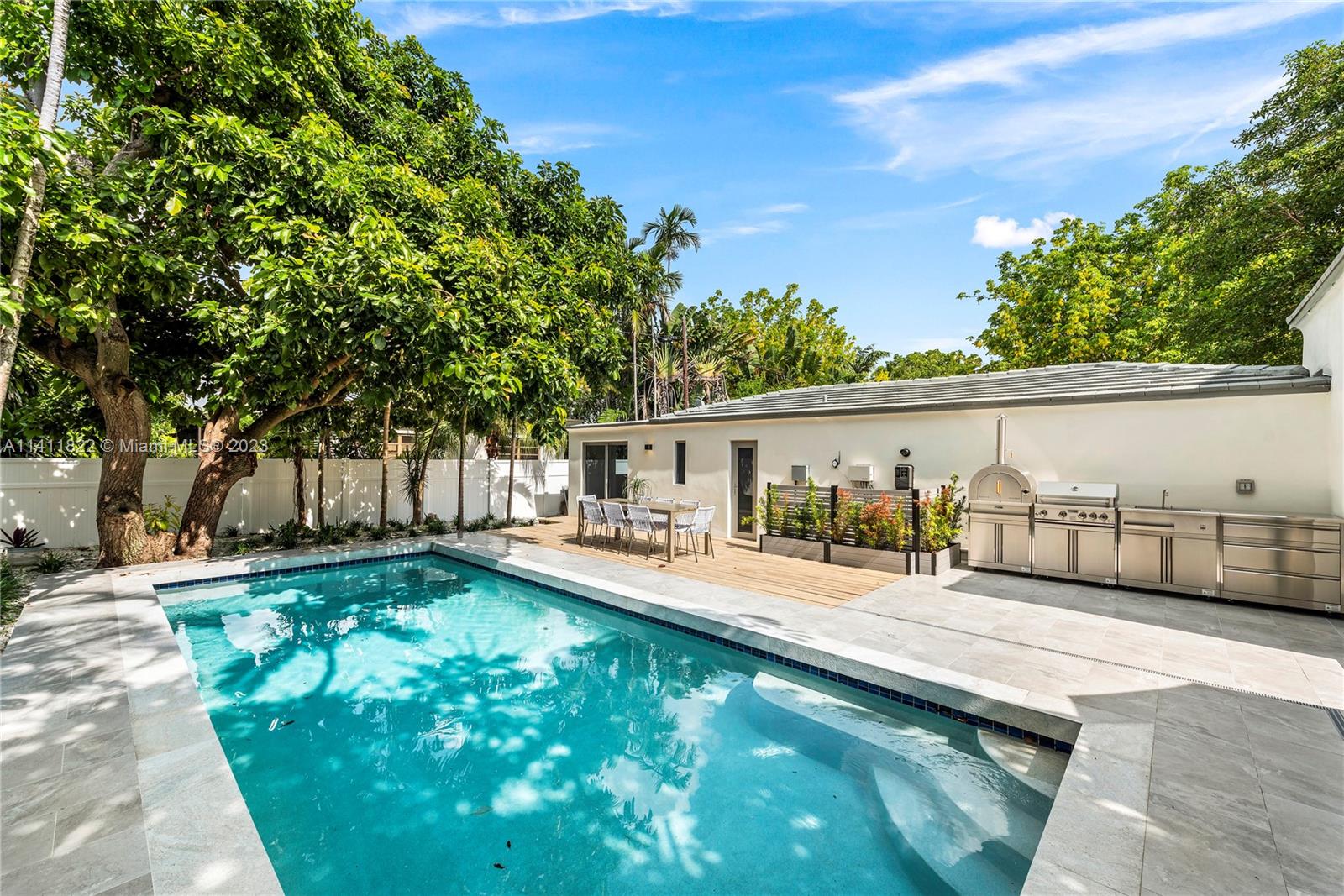 5956 Pine Tree Drive Miami Beach, FL 33140 - Photo 44 of 55 a view of a house with backyard and sitting area