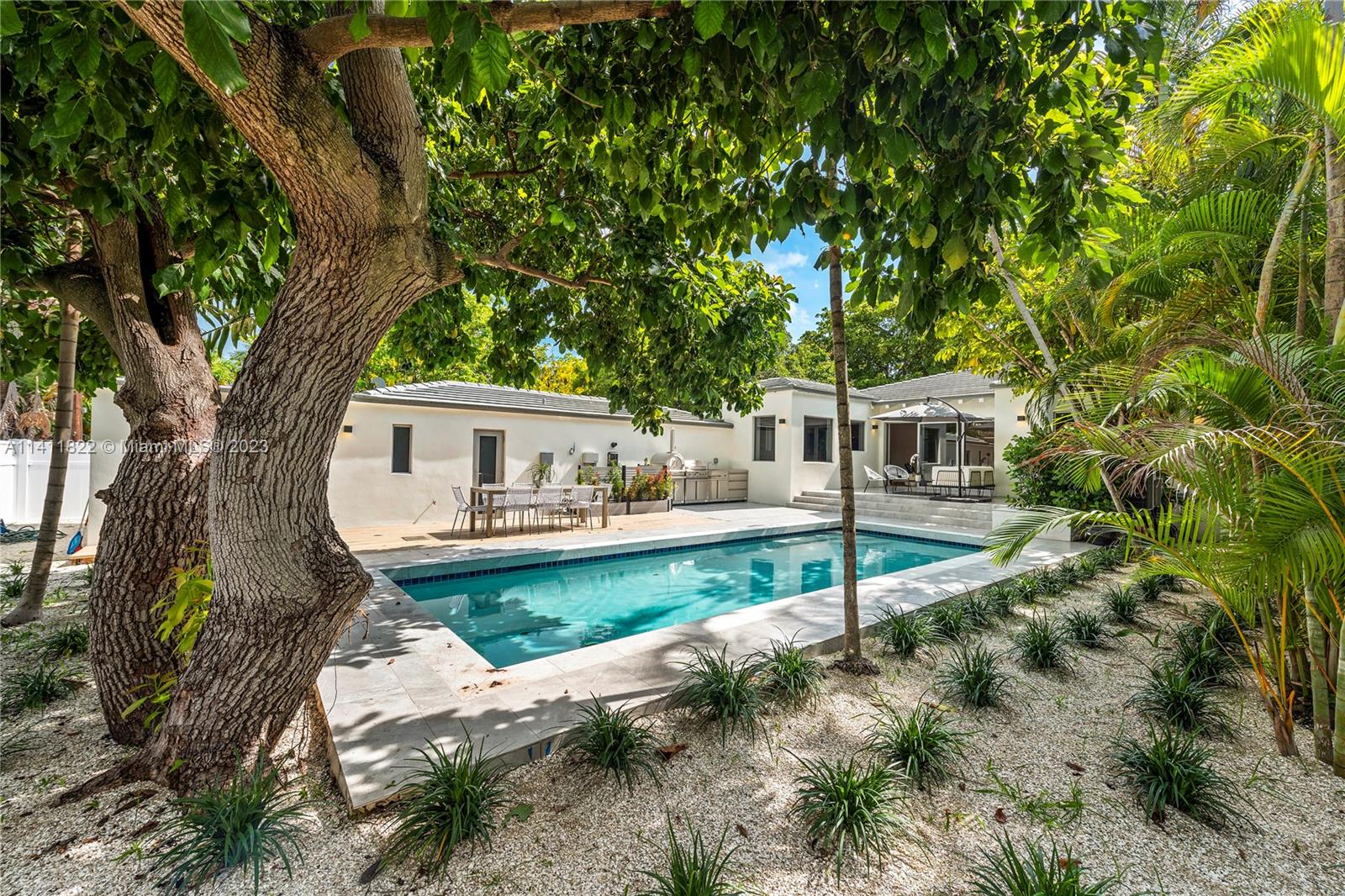 5956 Pine Tree Drive Miami Beach, FL 33140 - Photo 46 of 55 a view of a house with backyard and sitting area