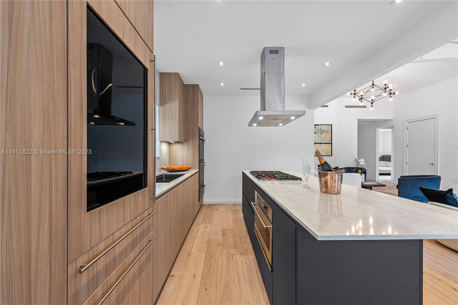 5956 Pine Tree Drive Miami Beach, FL 33140 - Photo 8 of 55 a kitchen with stainless steel appliances granite countertop a sink and refrigerator