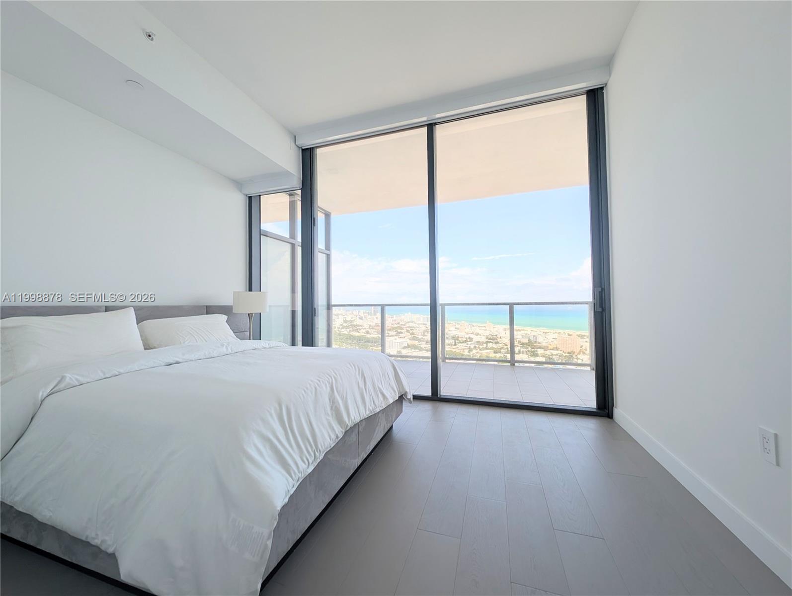a spacious bedroom with a large bed and a large window