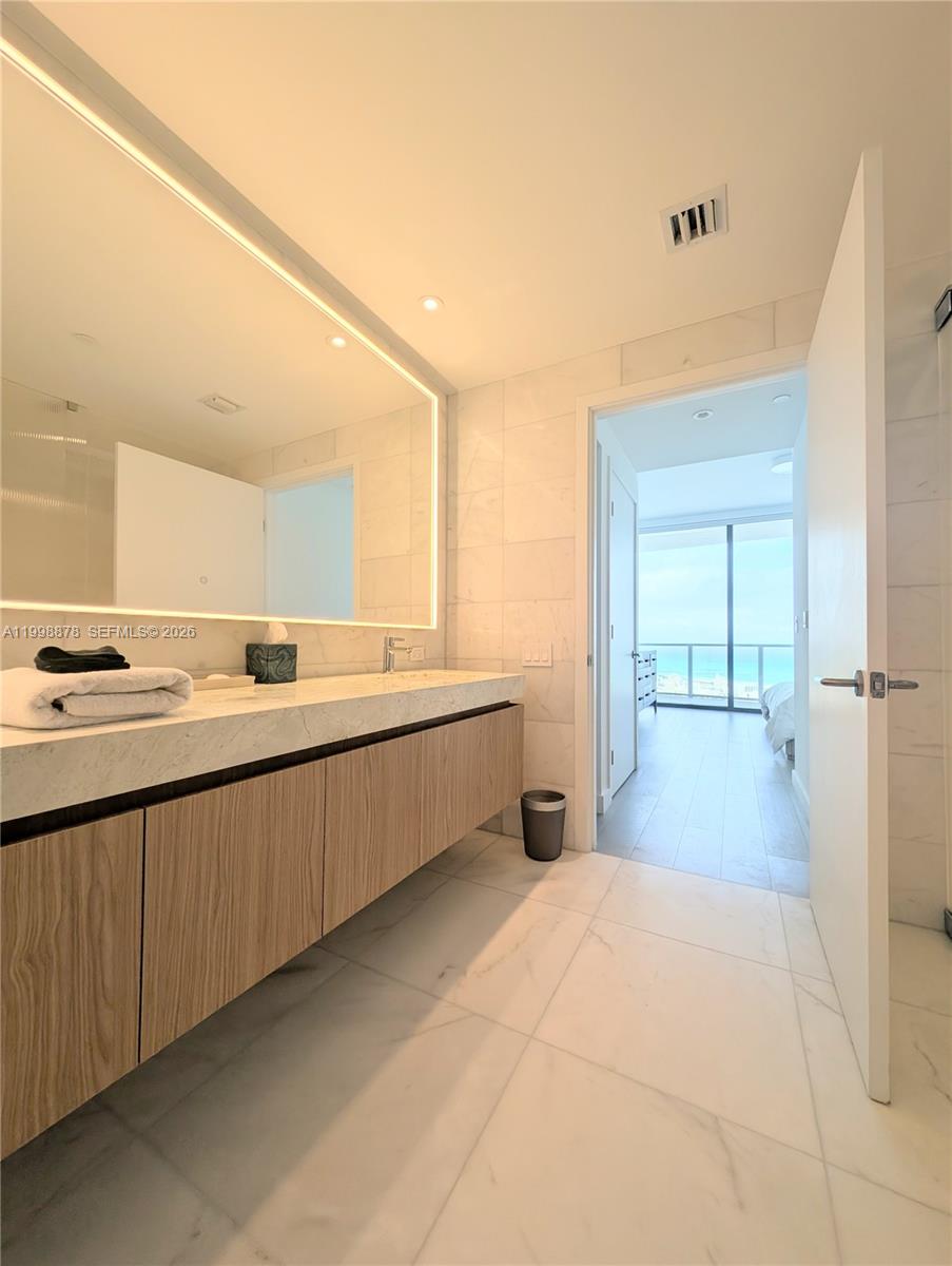 500 Alton Road, Unit 3905 Miami Beach, FL 33139 - Photo 11 of 27 a large white kitchen with a sink and cabinets