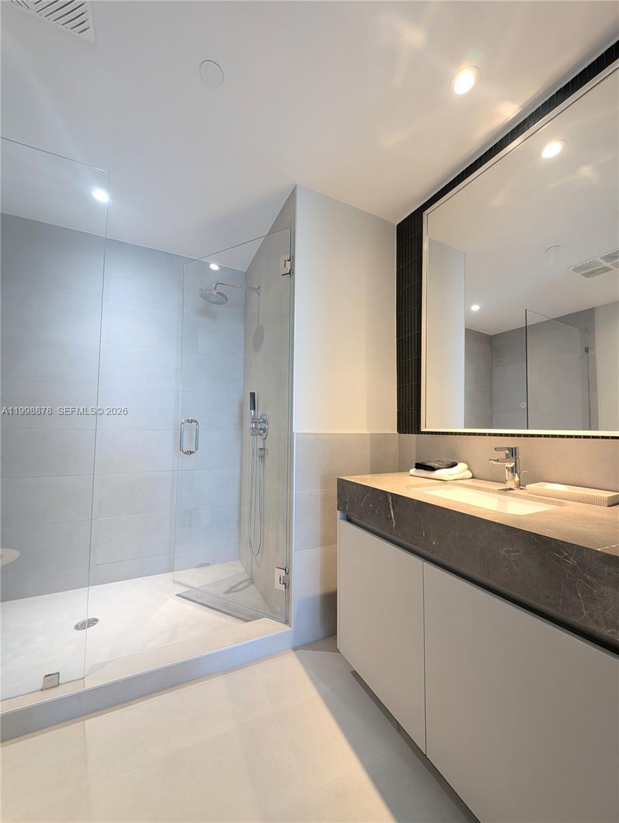 500 Alton Road, Unit 3905 Miami Beach, FL 33139 - Photo 2 of 27 a bathroom with a sink a toilet and shower