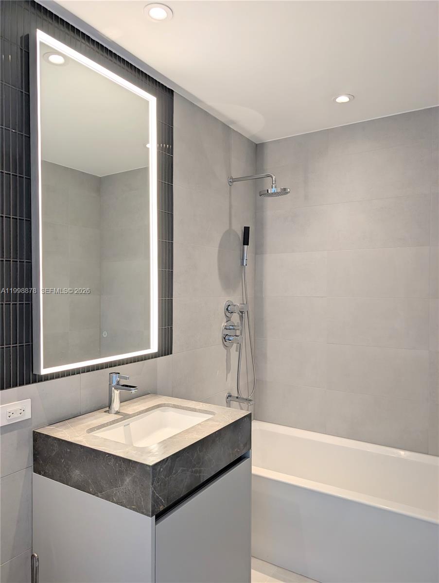500 Alton Road, Unit 3905 Miami Beach, FL 33139 - Photo 3 of 27 a bathroom with a sink and a mirror