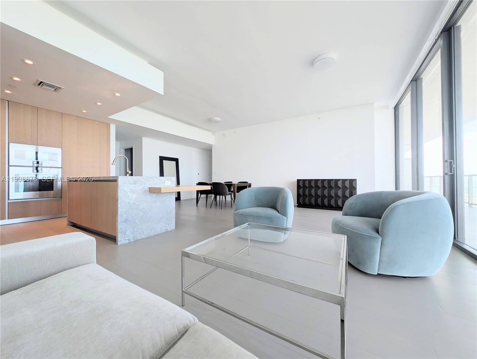 500 Alton Road, Unit 3905 Miami Beach, FL 33139 - Photo 6 of 27 a living room with furniture and a large window