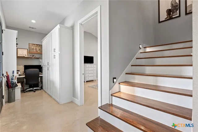 a view of entryway with furniture and staircase