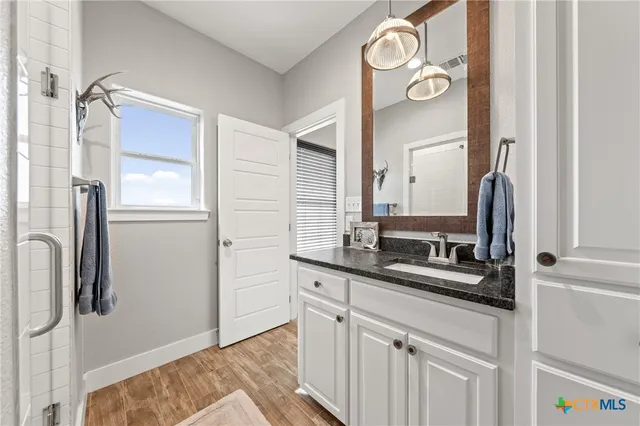 a bathroom with a sink and a mirror