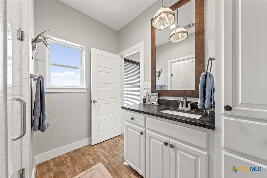 7351 Hackberry Road Holland, TX 76534 - Photo 25 of 41 a bathroom with a sink and a mirror