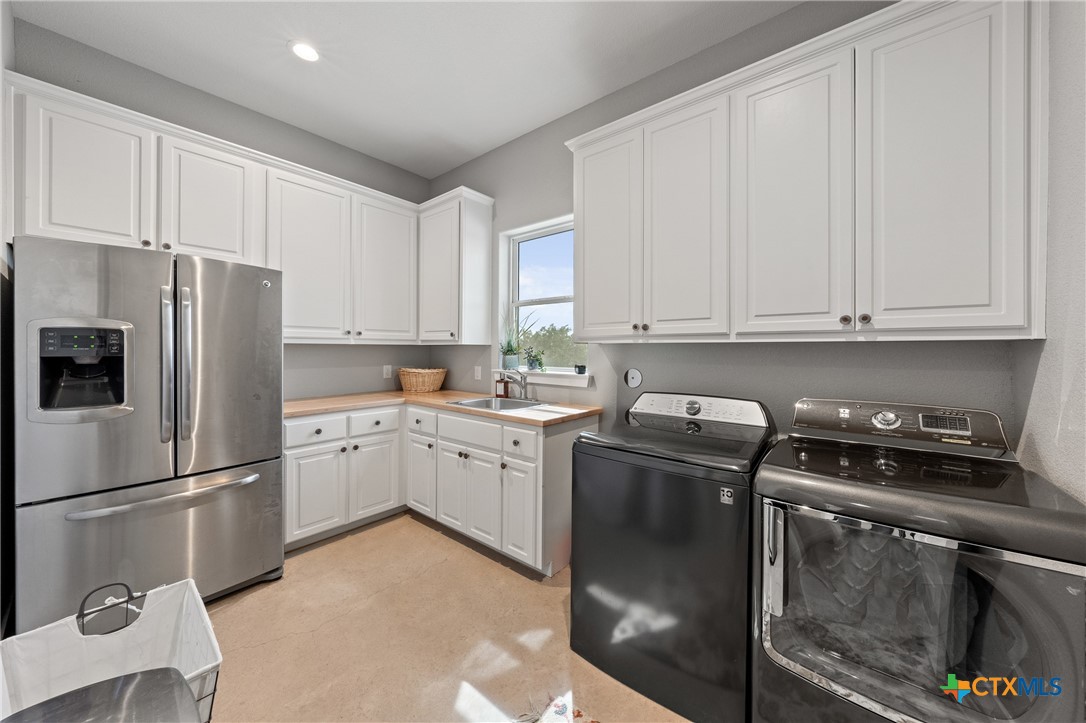 7351 Hackberry Road Holland, TX 76534 - Photo 31 of 41 a kitchen with a stove refrigerator and cabinets