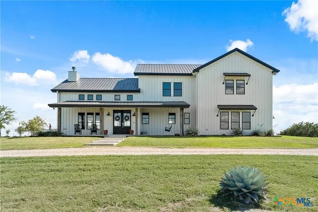 a view of a house with a swimming pool and a yard