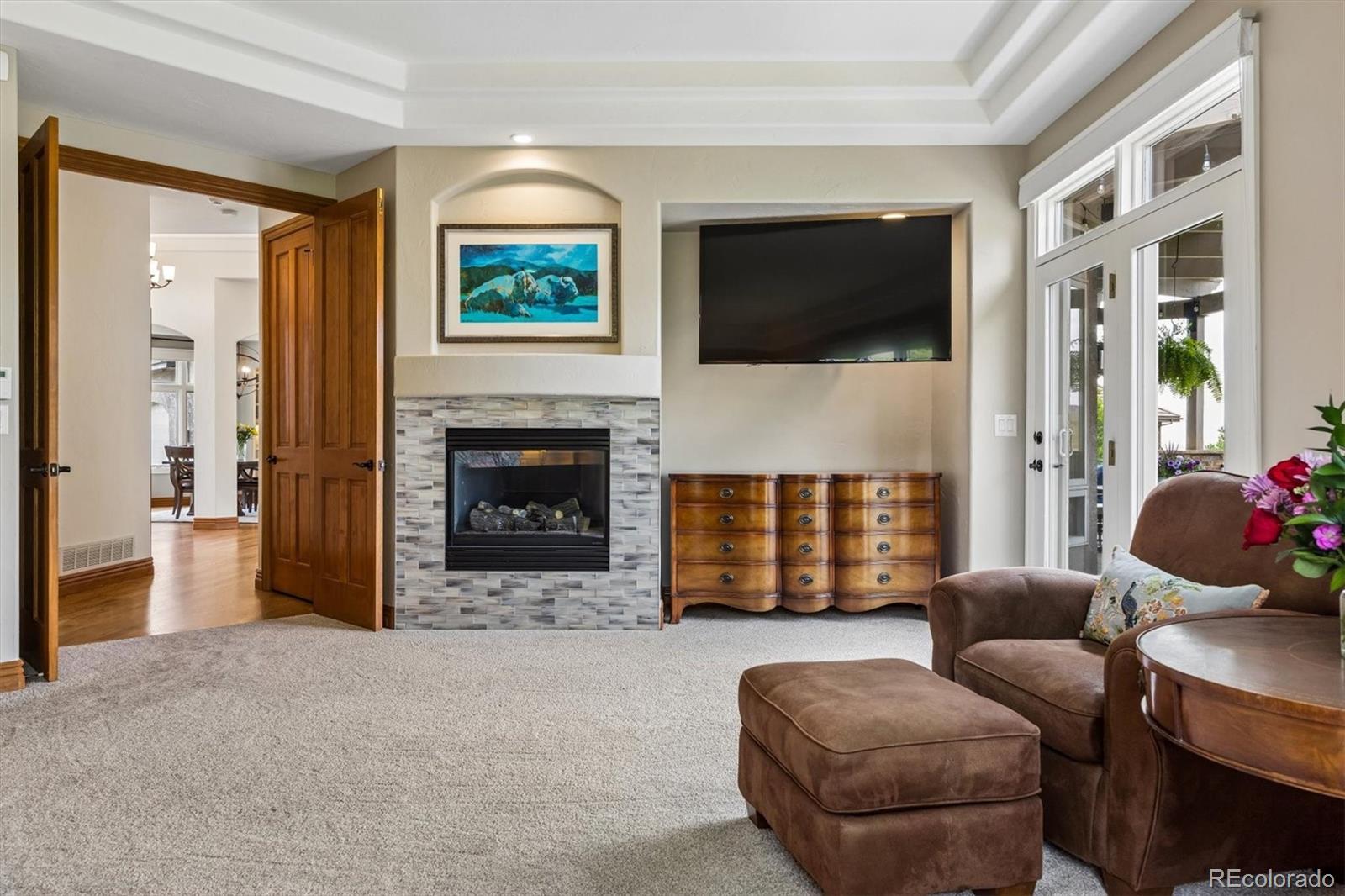 16422 Rocky Point Lane Morrison, CO 80465 - Photo 22 of 50 a living room with furniture a flat screen tv and a fireplace