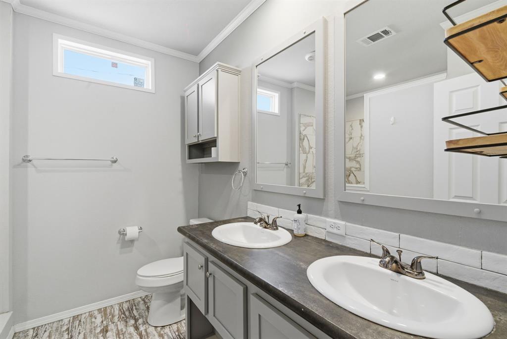 3639 Cedar Street Weatherford, TX 76088 - Photo 14 of 35 a bathroom with a sink toilet a mirror and shower