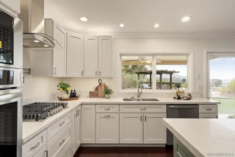 a kitchen with a sink stove and cabinets