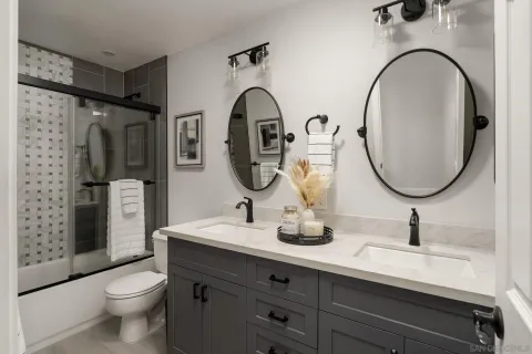 a bathroom with a toilet a sink and a mirror