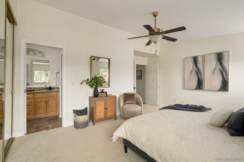 a bedroom with a bed and ceiling fan