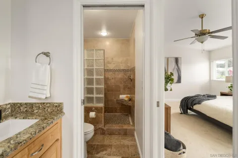 a bathroom with a tub shower vanity and a sink