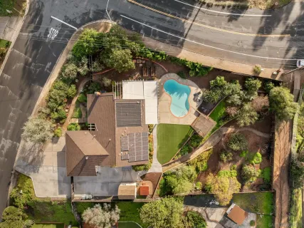 an aerial view of residential houses with outdoor space
