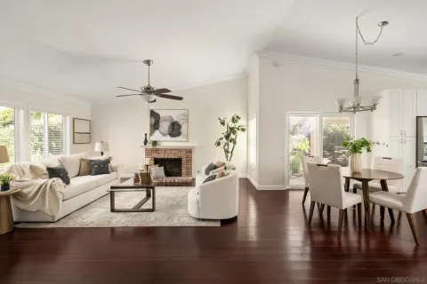 a living room with fireplace furniture and a chandelier