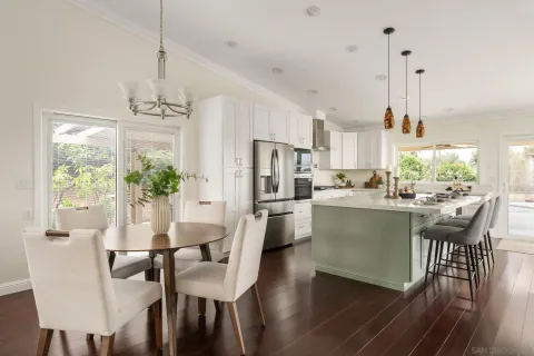 a dining room with furniture a chandelier and wooden floor