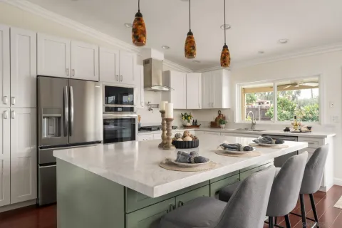 a kitchen with a sink a stove and chairs