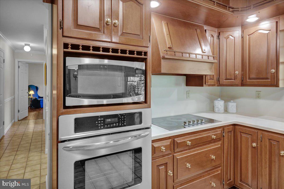 22 Lisa Road Sinking Spring, PA 19608 - Photo 20 of 60 a kitchen with stainless steel appliances granite countertop a stove microwave and cabinets