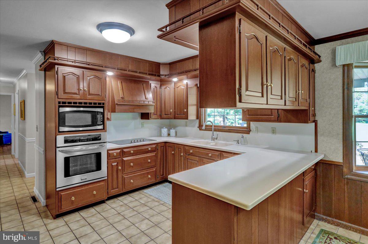 22 Lisa Road Sinking Spring, PA 19608 - Photo 22 of 60 a kitchen with stainless steel appliances granite countertop a sink stove and cabinets