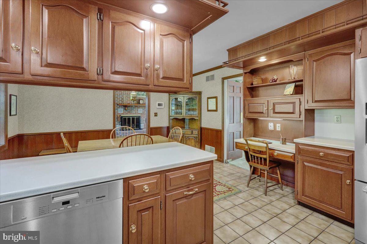 22 Lisa Road Sinking Spring, PA 19608 - Photo 24 of 60 a kitchen with stainless steel appliances granite countertop a refrigerator and wooden cabinets