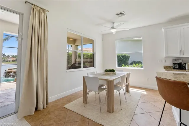 a living room with furniture a table and a large window