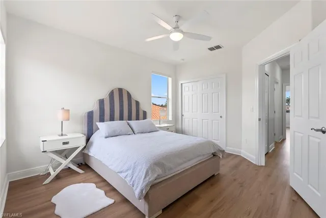 a bathroom with a granite countertop double vanity sink a mirror and a bathtub