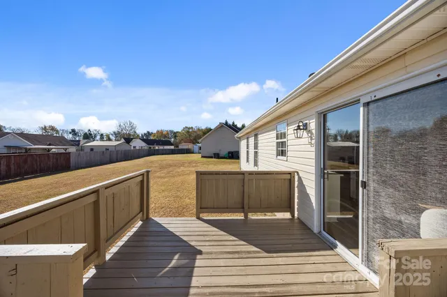 a view of a balcony with wooden floor and iron fence