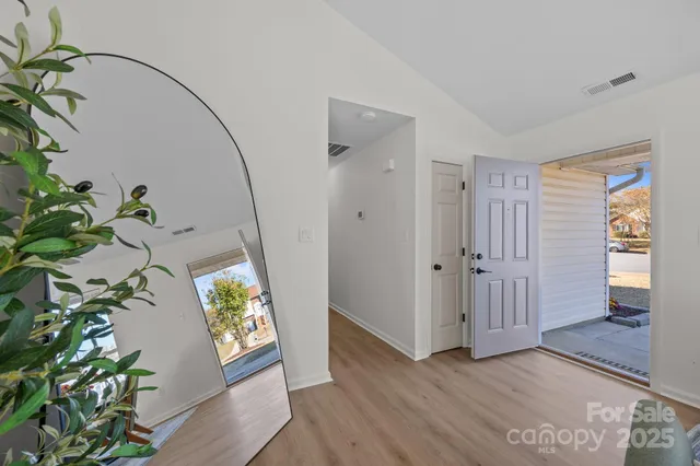 a view of an entryway with wooden floor
