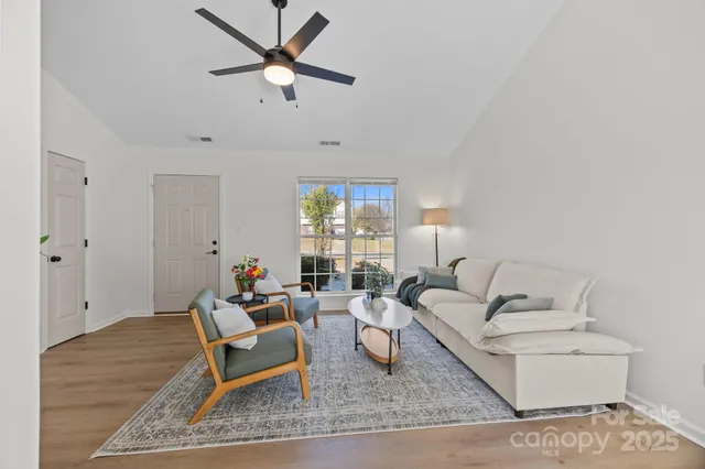 a living room with furniture and wooden floor