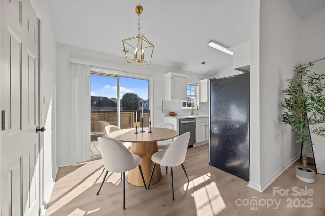 a dining room with furniture a chandelier and window