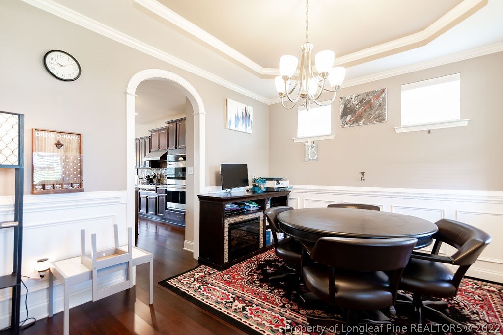 335 Turriff Way Cameron, NC 28326 - Photo 11 of 50 a room with furniture a chandelier a rug and a window