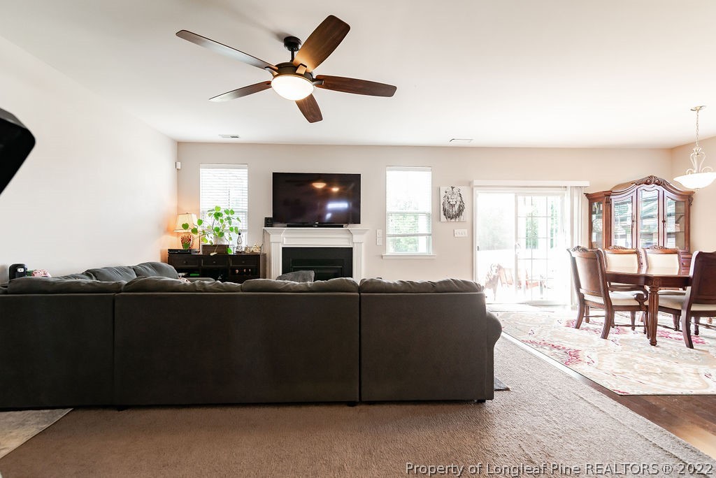 335 Turriff Way Cameron, NC 28326 - Photo 15 of 50 a living room with furniture a flat screen tv and a fireplace