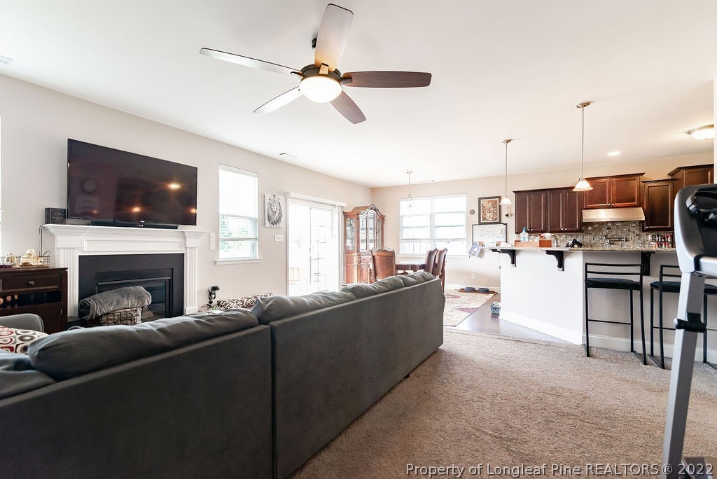 335 Turriff Way Cameron, NC 28326 - Photo 16 of 50 a living room with furniture and a flat screen tv