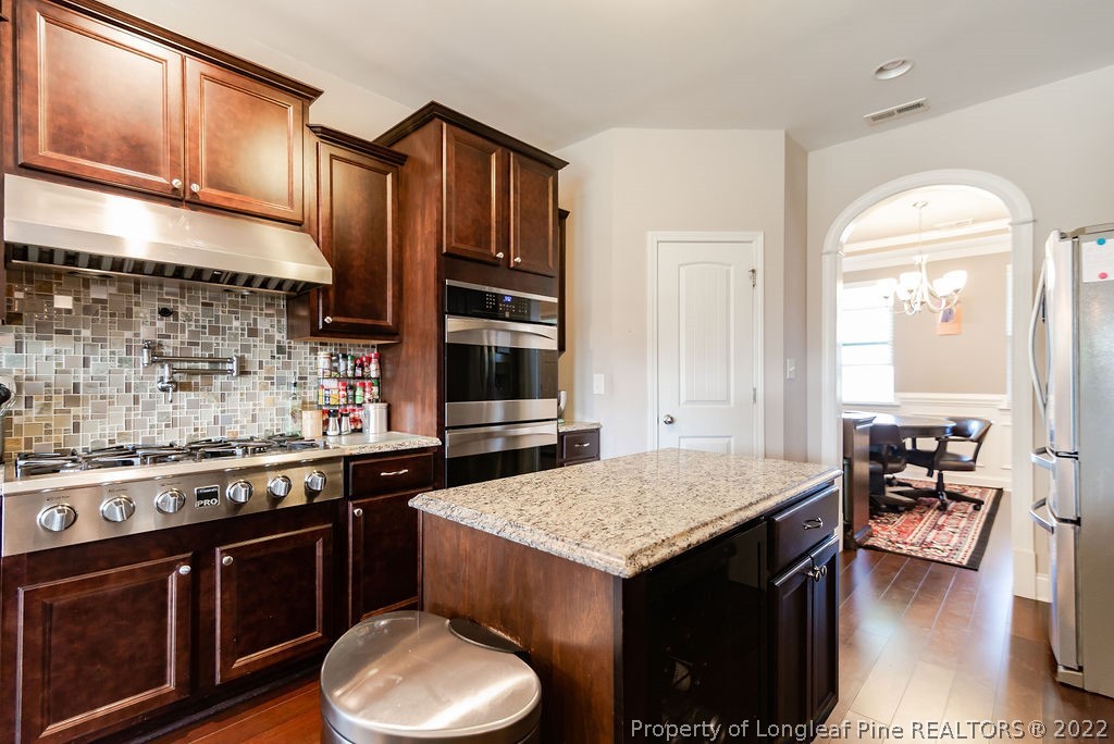 335 Turriff Way Cameron, NC 28326 - Photo 22 of 50 a kitchen with a stove a sink and a refrigerator