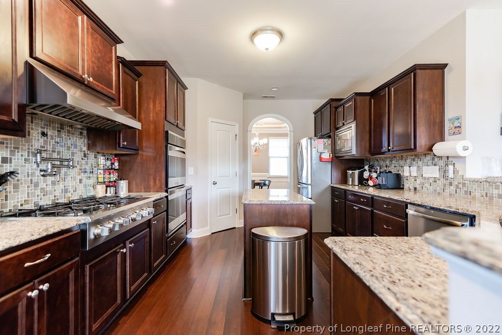 335 Turriff Way Cameron, NC 28326 - Photo 23 of 50 a kitchen with a stove top oven sink and cabinets