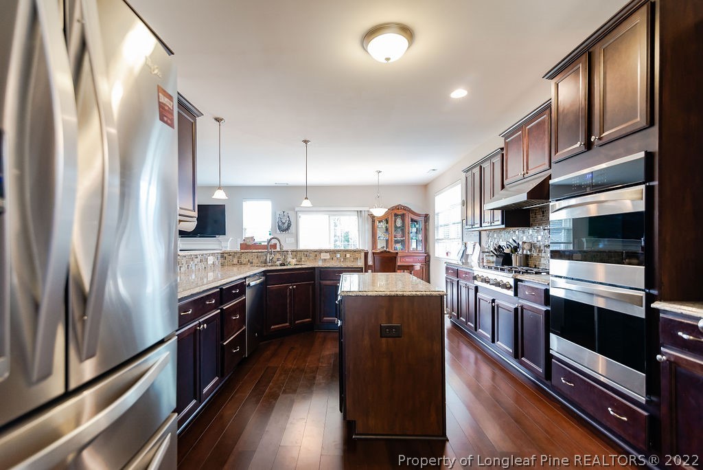 335 Turriff Way Cameron, NC 28326 - Photo 24 of 50 a kitchen with stainless steel appliances granite countertop a refrigerator a stove and a sink