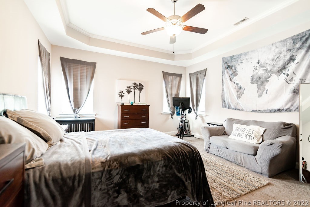 335 Turriff Way Cameron, NC 28326 - Photo 26 of 50 a bedroom with a large bed couch and a window