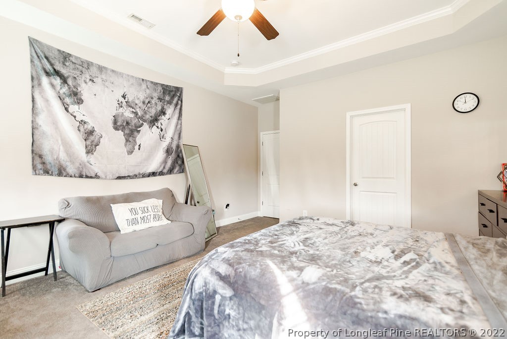 335 Turriff Way Cameron, NC 28326 - Photo 27 of 50 a bedroom with a bed and a couch